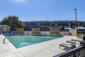 A swimming pool with a building in the background